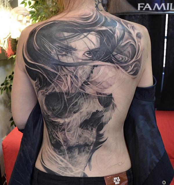  63 girls and skull tattoo on the back of the woman 