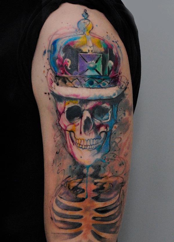 77 Watercolor Smiling Skull Tattoo