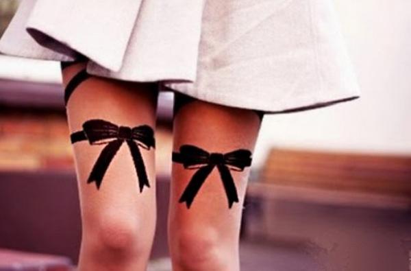 7 Bows on thigh tattoo