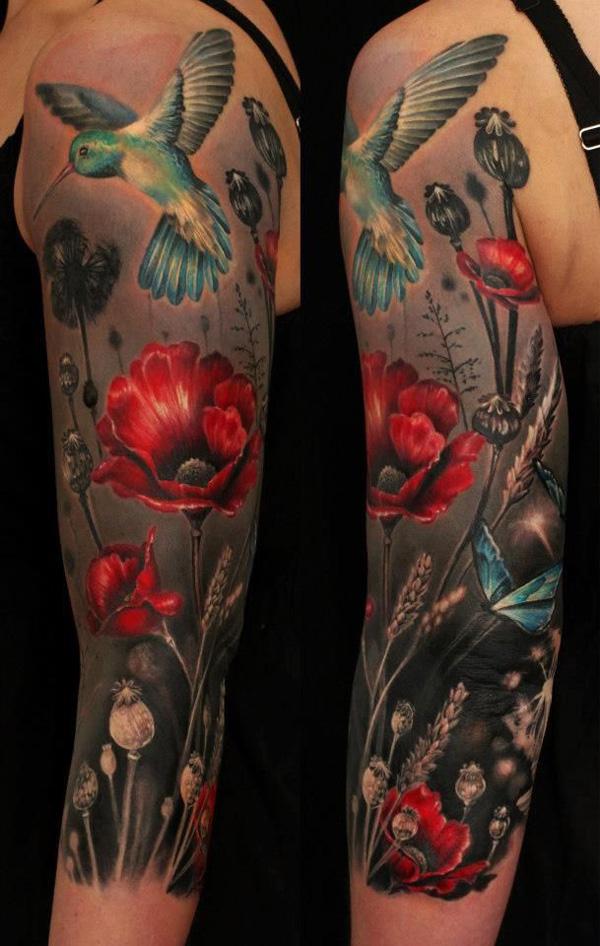 35 Hummingbird, butterfly, and poppy arm tattoo