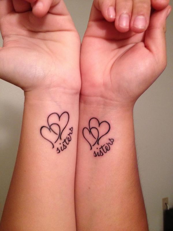 Wrist sister Tattoos - When the tattoos are worn by two sisters, you know the meaning of of the double heart symbol.