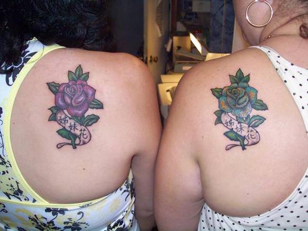 Sister tattoos with pink and blue roses with Chinese words “sister flowers”. The beauty which will never change.