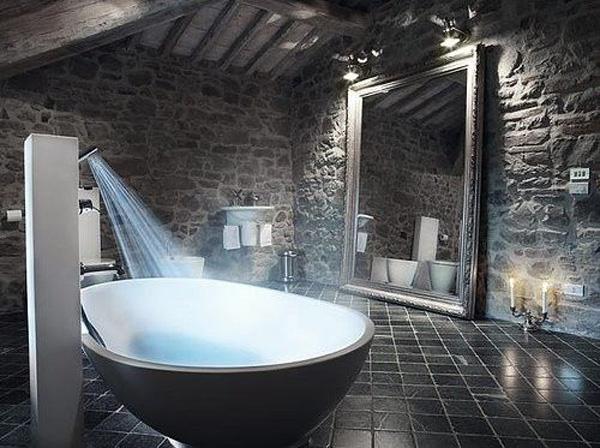 A bowl shaped white tub with a shower attached on the side.