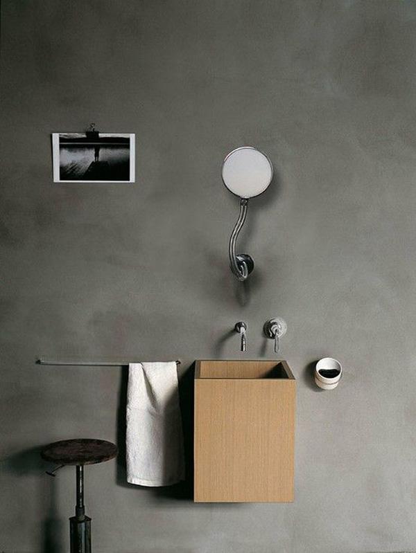 Stone made sink stands on a wooden support in retro style.