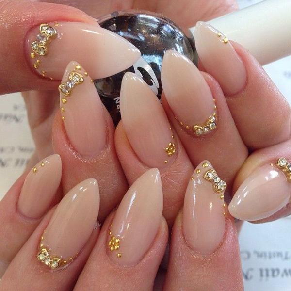 Simplicity is beauty as they always say. This is because the simpler you go, the more your true beauty shines. These stiletto nails truly speak for themselves. They do not need so much color, simply a plain nude polish and a couple of elegant gold acrylic and silver beads are enough to do the job.