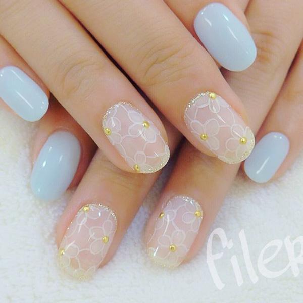 As much as there are ridiculously grand nail art styles, simple can also still be beautiful. Paint your nails in clear white acrylic and baby blue colors while accentuating it with gold beads posing in the center of the flower petals. This style is perfect for everyday activities and can match your outfit wherever you may need to go.