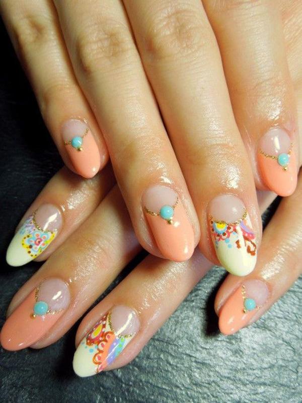 Go true with orange on this simple yet enjoyable looking nail art design. The flowers are playfully painted with multi colors making your eyes dance and jump from one color to another. The near peach plain color helps deviate your vision from the swirly designs of the flowers and rests your eyes until you look into another nail.