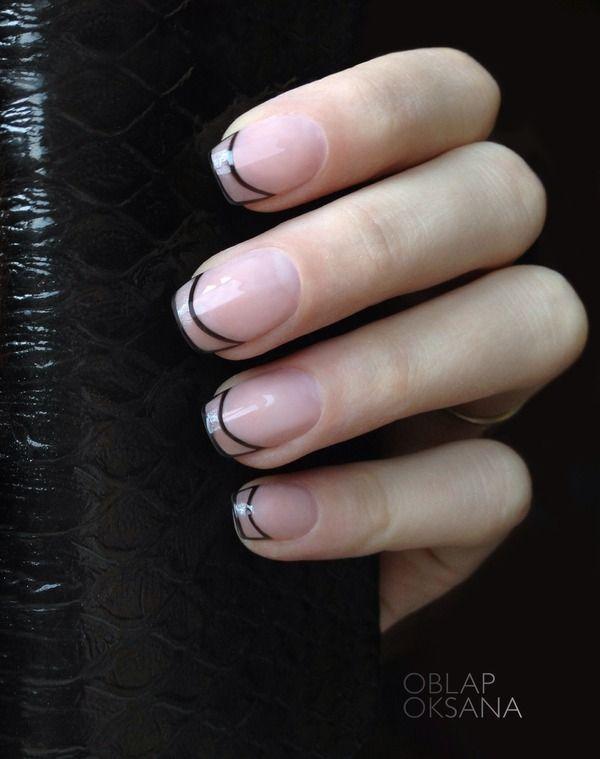 Trendy tips! This French manicure has a clear nail polish used as base and played around with shaping the French tip instead of filling it in. the black polish shaping the tips of the nails looks perfectly on point.