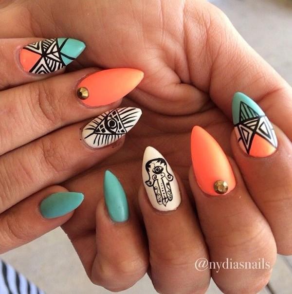 Be bold and creative with this tribal inspired stiletto nails. Coated with blue and orange color combinations, you will simply love the lines and stripes that play along your nails. A very creative looking nail art design you will fall in love with.