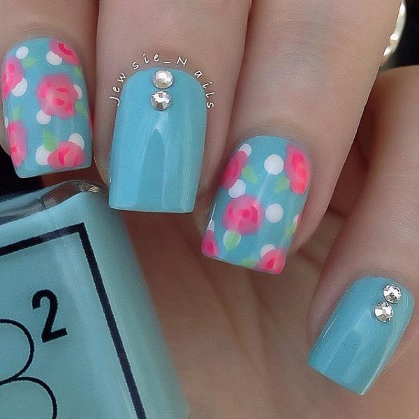 Blue floral themed nail art design. This nail art uses light blue polish is used as the base color with pink and white rose details on top.