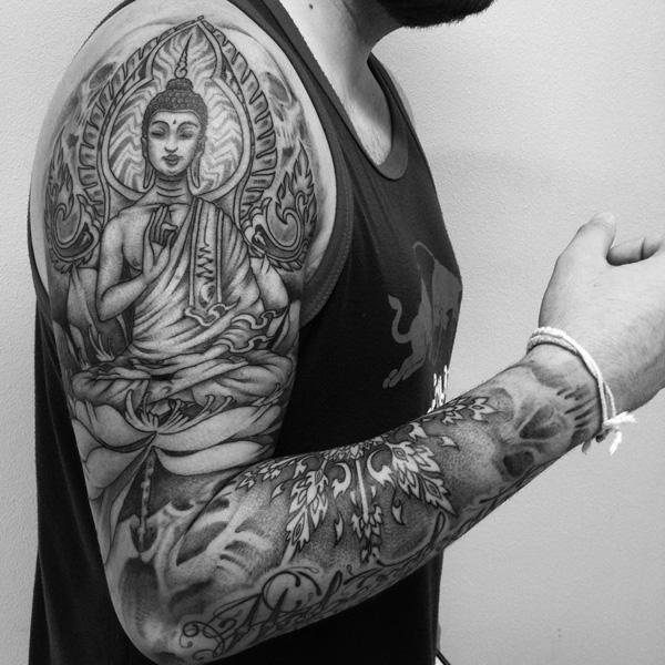 Lastly, here’s another Buddha sleeve tattoo with a variety of Buddhist symbols and adornments. 