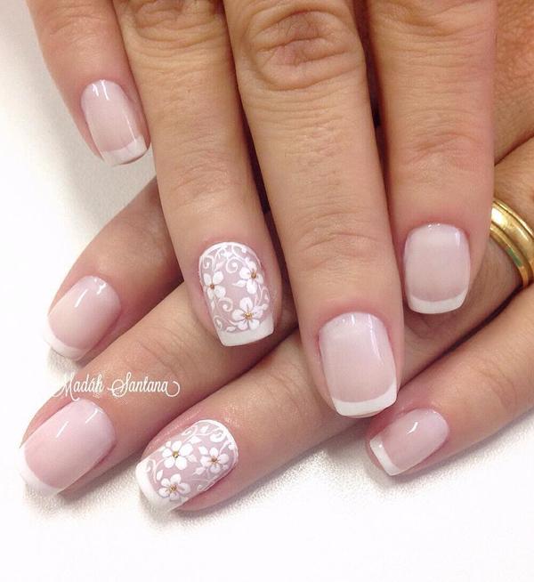 Nude nail art with floral details and French tips. Combing your French tips with floral details to make the nude nail polish from beneath stand out even more.