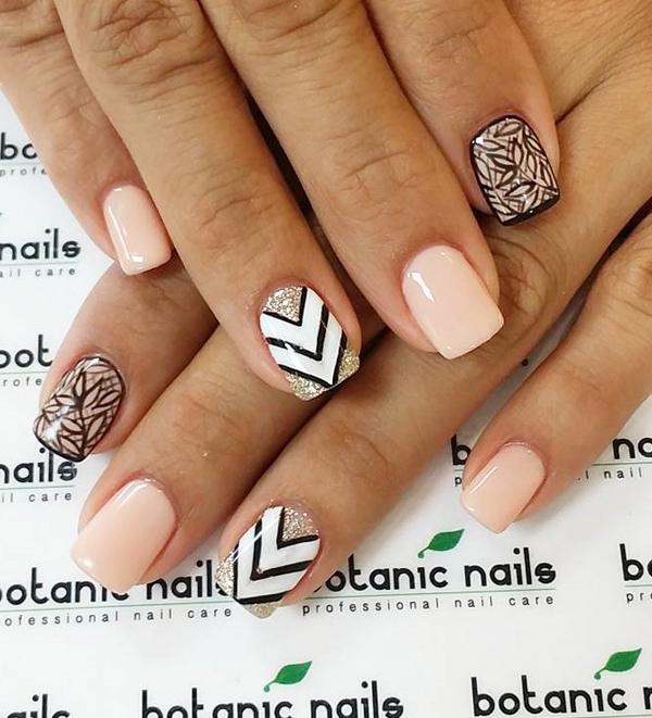 Nude nail polish in combination with black and white nail polish. Geometric shapes and leaves make this nail art design so interesting to look at. The glitter polish added help make it stand out more.