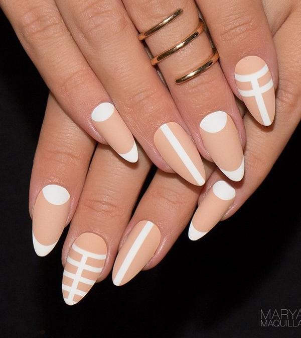 White and nude nail art design. A combination of French tips, cuticle shapes as well as diagonal and horizontal intersecting lines is painted creating a wonderful design.