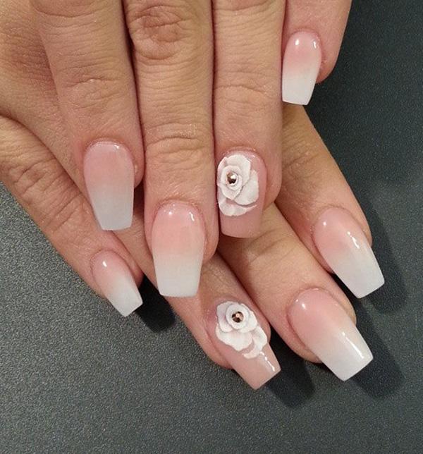 Beautiful white and nude gradient nail art. This style looks very neat and clean. Make it stand out by adding white flower embellishments on top with silver beads.