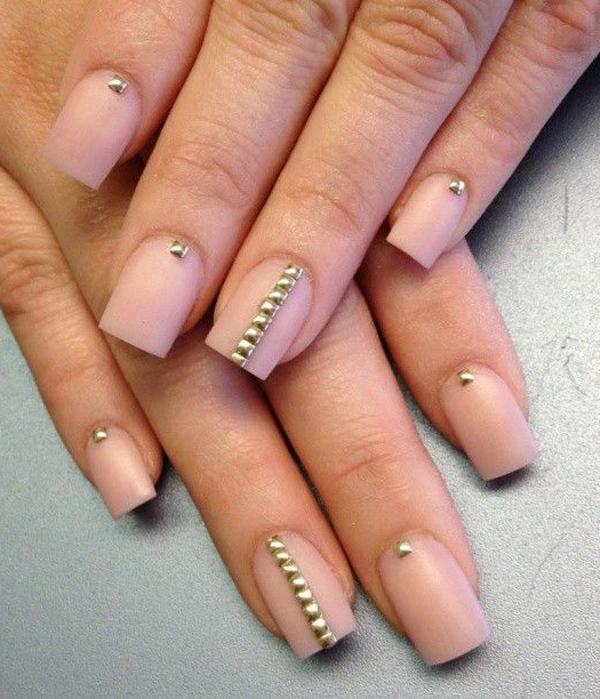 Elegant looking nude nail art with pretty gold beads on top. The beads add to the sheer elegance that the nude polish exudes.