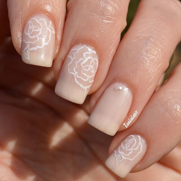 Floral inspired nude nail art design. make your nude nail art have more life by adding line details of flowers by the cuticle area in striking white polish. 