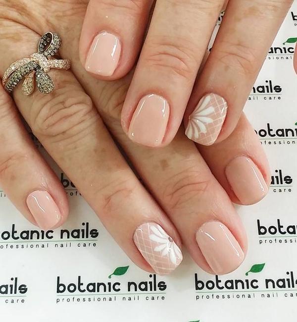 Simple nude nail art design with details on top in white polish. Keep your nails clean but pretty with nude polish and a bit of detail in white above your base color.