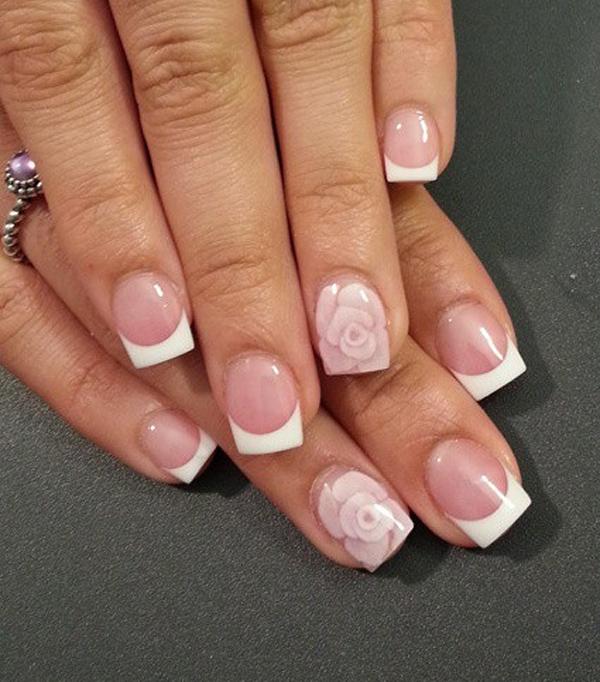 Wonderful French tips over a nude nail polish design. Let your nude nails stand out by adding cute flower embellishments on top.
