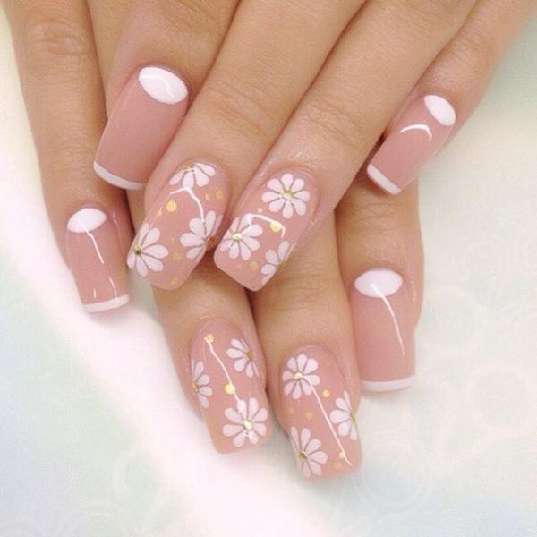 Wonderful flower inspired nude nail art design. Bring a cheery vibe to your nude nails by adding simple flowers in white nail polish along with gold sequins. You can also see a bit of French tip and cuticle paint in white.