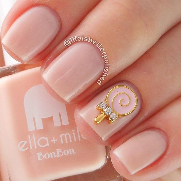A neat and tidy looking nude nail art. Add a gold lollipop shaped embellishment on top with silver beads, making the nail art twice as sophisticated as it has already been.