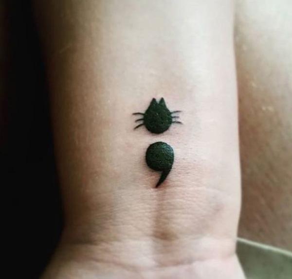 Placing a semicolon near your heart in a heart-shaped polka dot tattoo