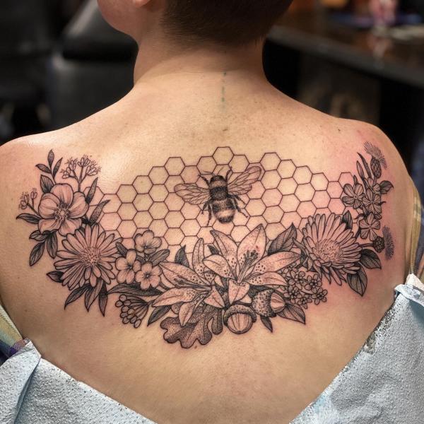 Bee and honeycomb with flowers back tattoo