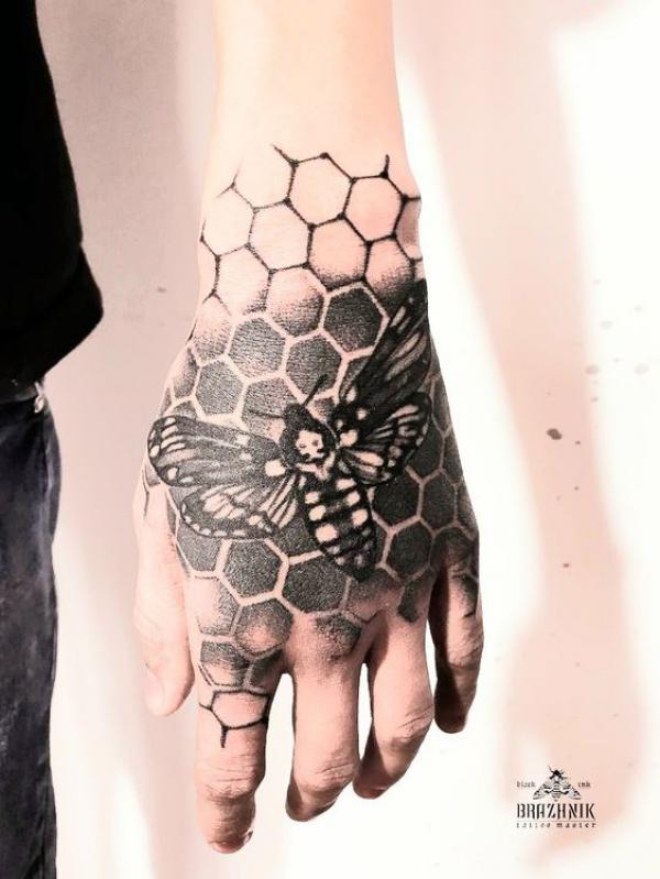 Death moth on honeycomb hand tattoo