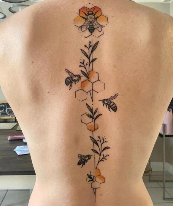 Honeycomb and bee spine tattoo