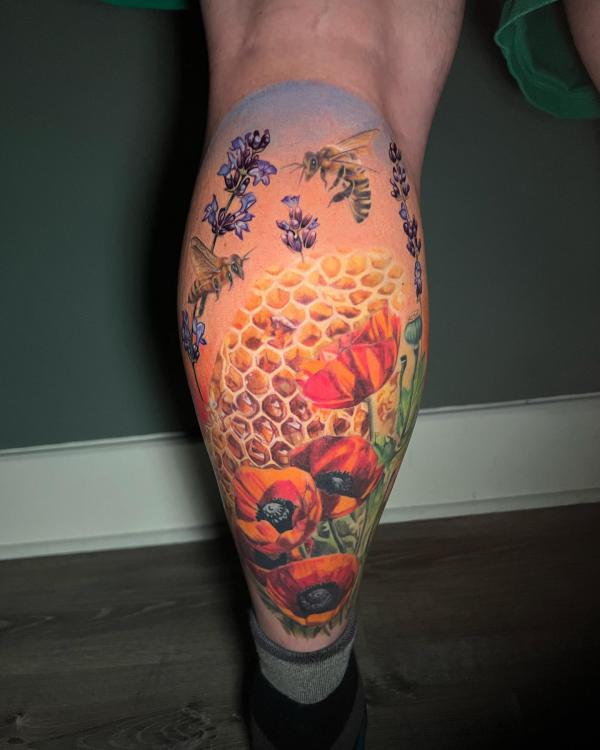 Honeycomb and bee with poppy and lavender flowers calf tattoo