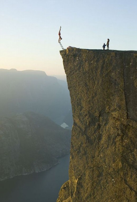 art of balance  Handstand on a ladder on the edge of a cliff
