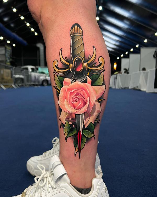 Green dagger through a pink rose