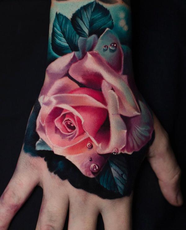 Pink rose with water droplets hand tattoo