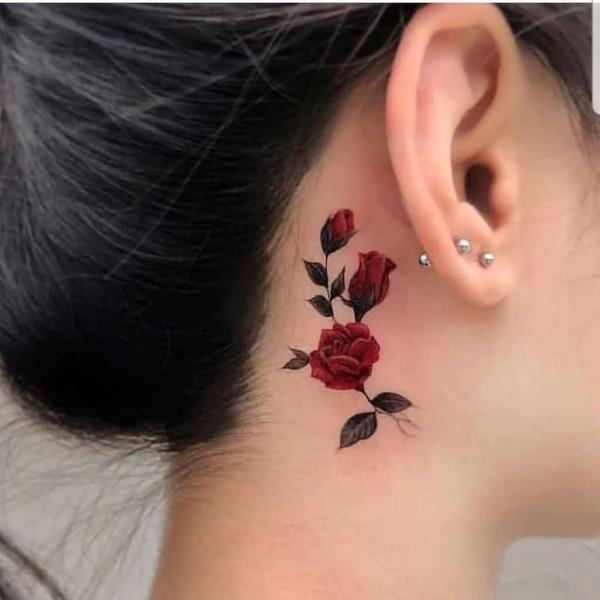 Red rose tattoo behind year