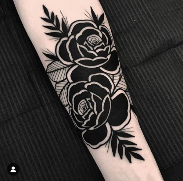 Traditional black and white rose forearm tattoo