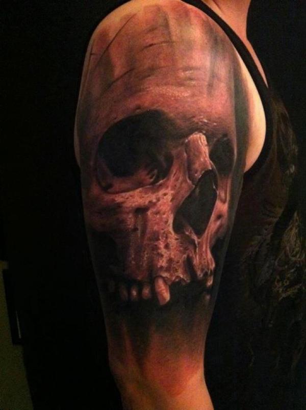 Skull ear tattoo