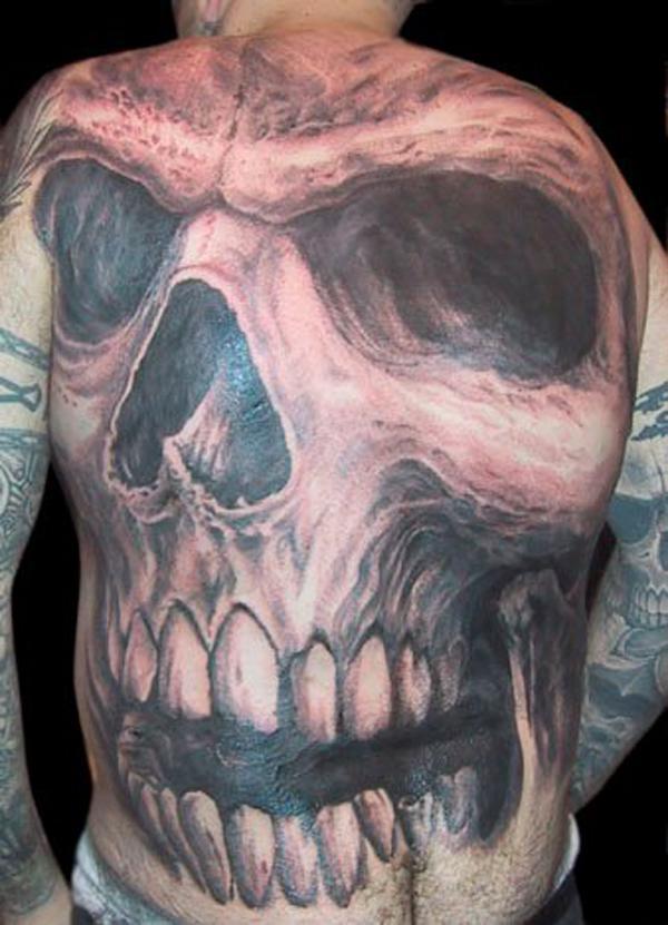 Roses and skull melted in flesh tattoo