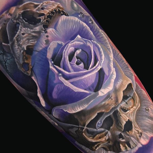 Skull with moth and rose tattoo