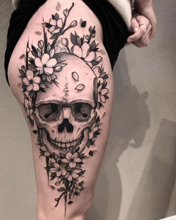 Black and white skull and cherry blossom thigh tattoo