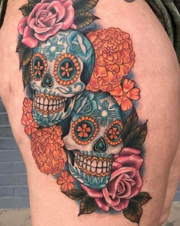 Colorful sugar skull with rose and marigold flowers