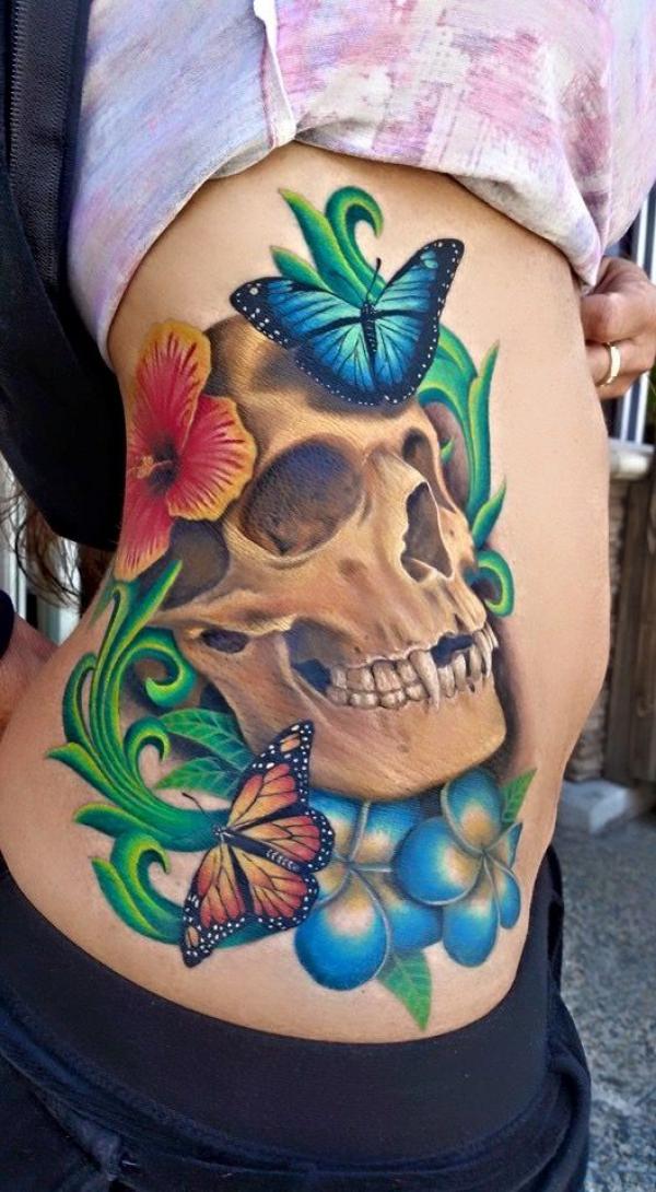 Feminine skull and blue butterfly tattoo