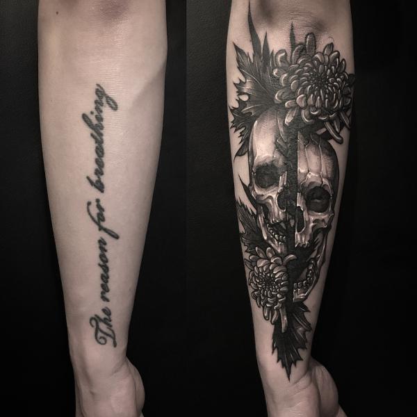 Skull and chrysanthemum cover up tattoo on forearm