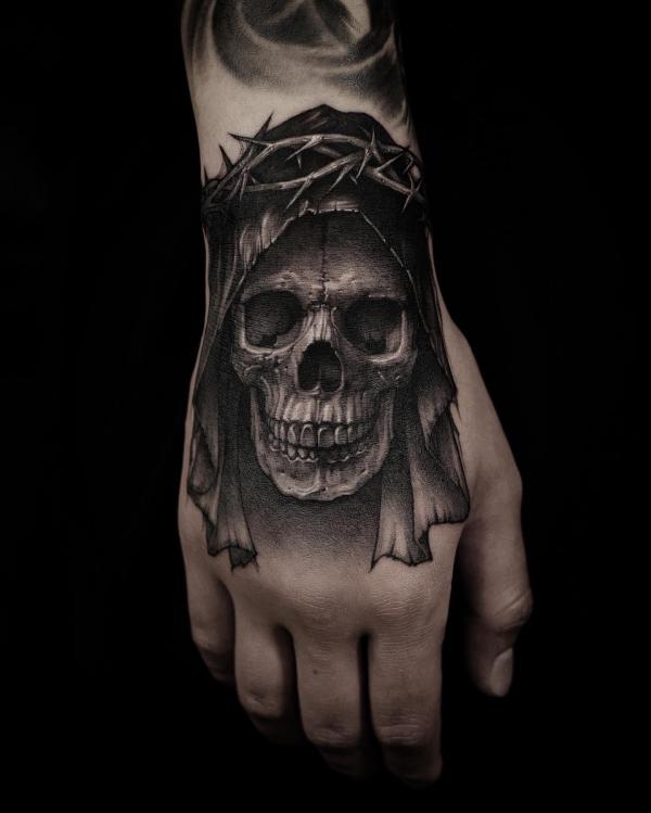 Skull with crown of thorns hand tattoo