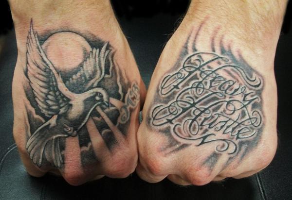 Hand tattoos of the words amore and art