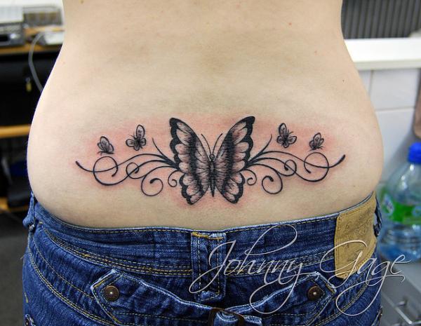 Symmetric butterflies tattoo in tribal style for women