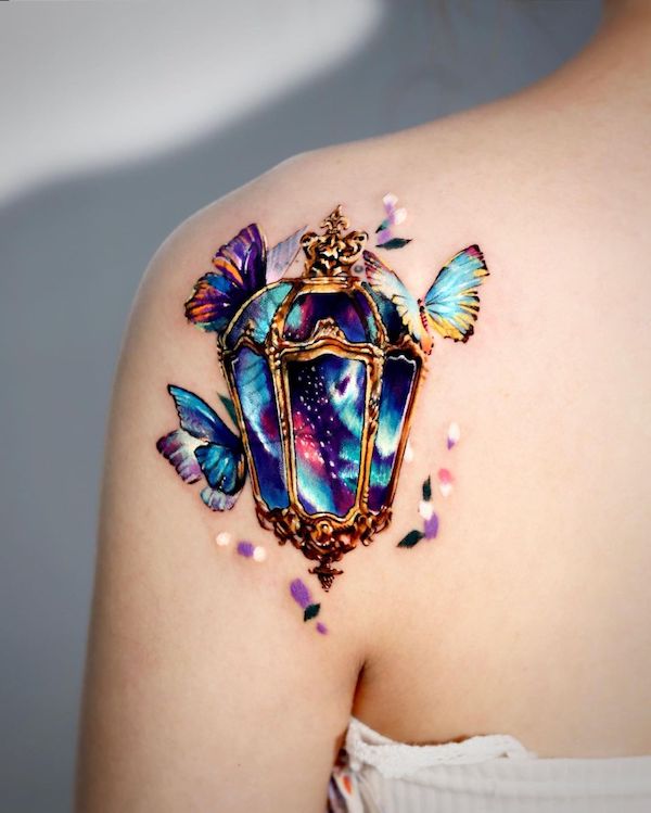 Fantastic back tattoo of golden street light surrounded by vivid butterflies