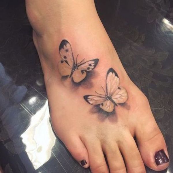 Two realistic butterflies tattooed on the foot