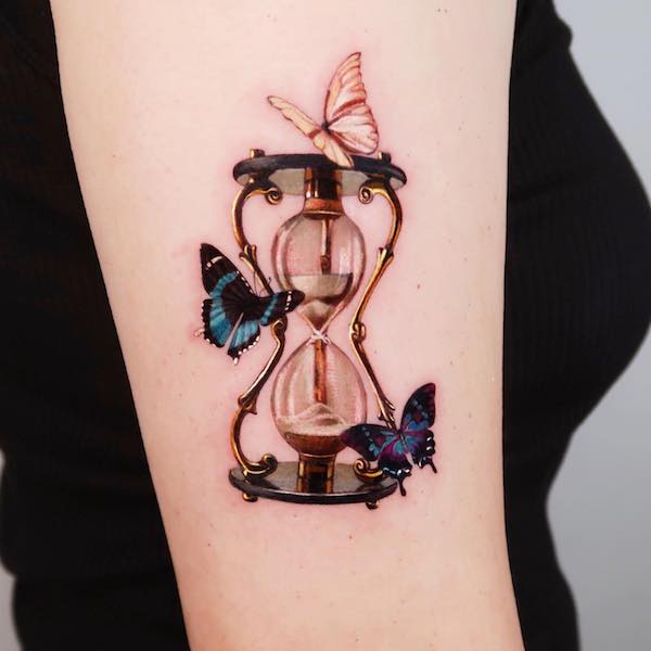 butterfly tattoo of Whimsical hourglass surrounded by three butterflies