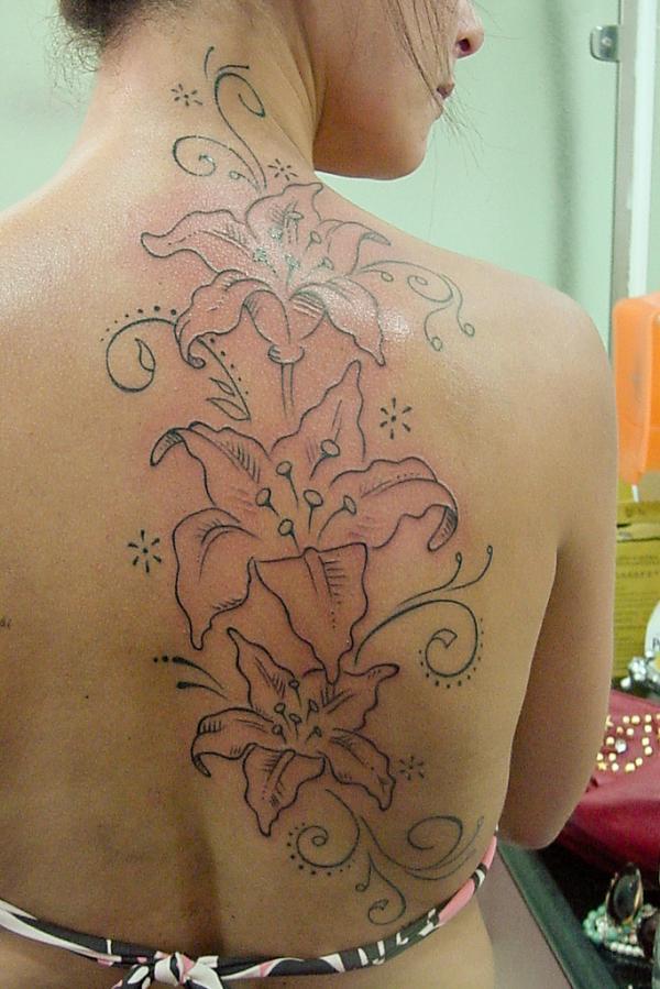 Lily outline back tattoo with stars