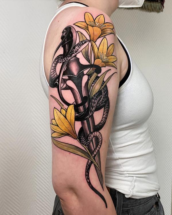A snake entwined with dagger and lily flowers